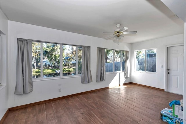 unfurnished room with dark hardwood / wood-style floors and ceiling fan