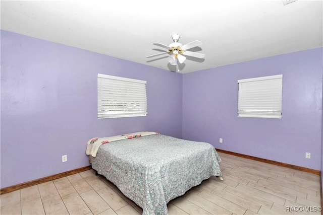 bedroom with light hardwood / wood-style flooring and ceiling fan