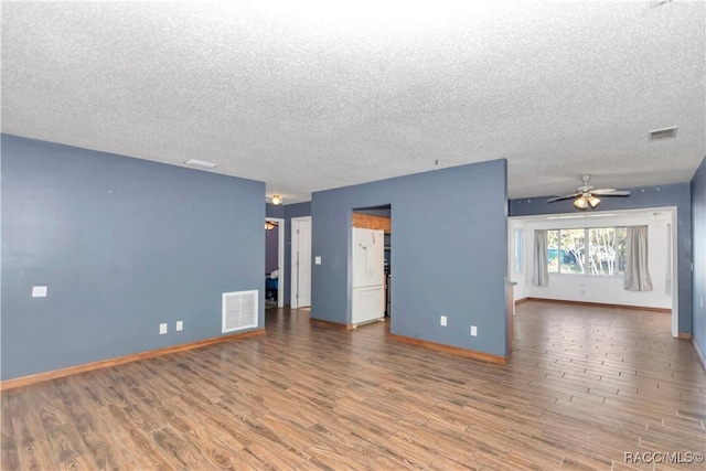 empty room featuring wood-type flooring, a textured ceiling, and ceiling fan