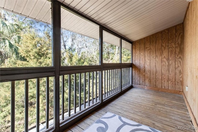 unfurnished sunroom with plenty of natural light and vaulted ceiling