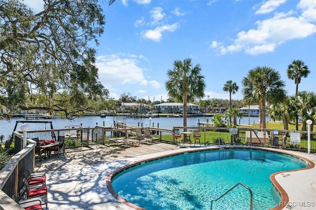 pool featuring a water view and fence