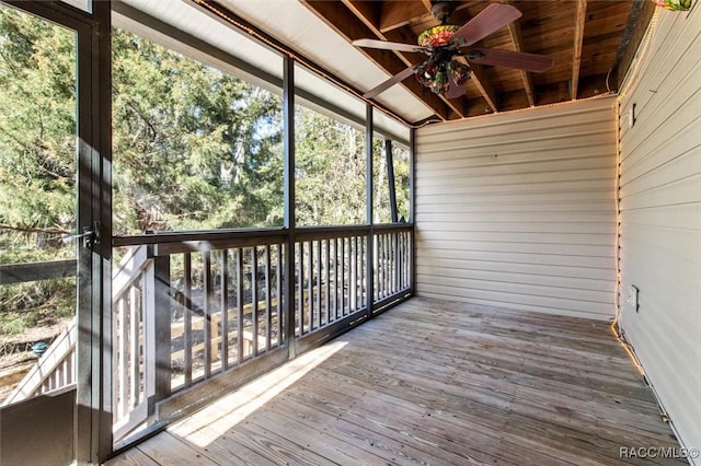 unfurnished sunroom with ceiling fan