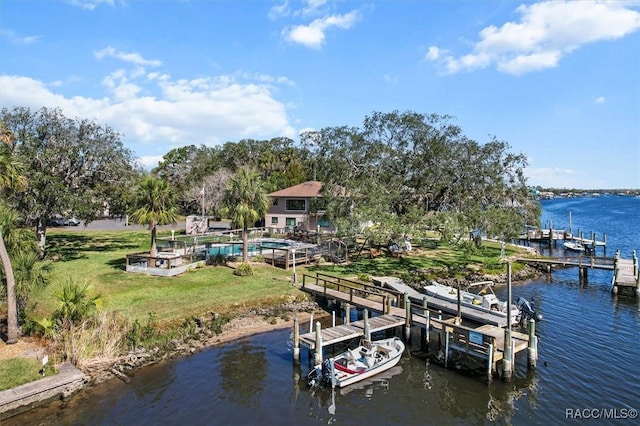 view of dock with a yard, a water view, and boat lift