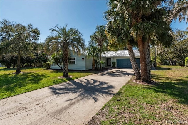 single story home with a garage and a front lawn