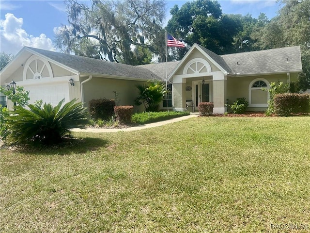 2745 N Canterbury Lake Dr, Hernando, FL 34442 - view of front of home with a front lawn, a garage, and stucco siding