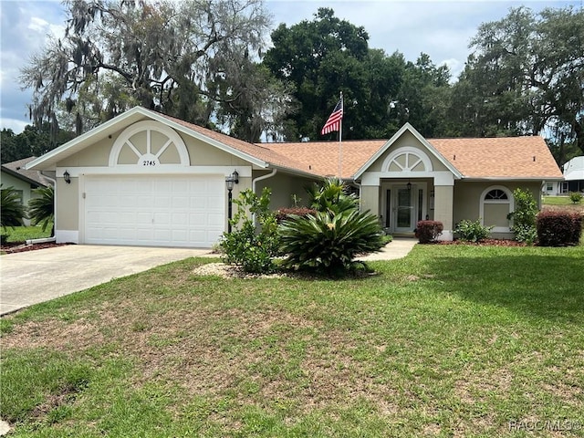 2745 N Canterbury Lake Dr, Hernando, FL 34442 - ranch-style home featuring driveway, an attached garage, a front yard, and stucco siding