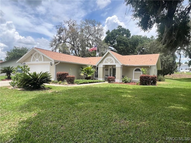 2745 N Canterbury Lake Dr, Hernando, FL 34442 - ranch-style home featuring an attached garage, a front yard, and stucco siding