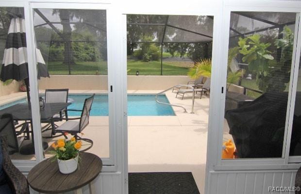 2745 N Canterbury Lake Dr, Hernando, FL 34442 - swimming pool with glass enclosure and a patio area