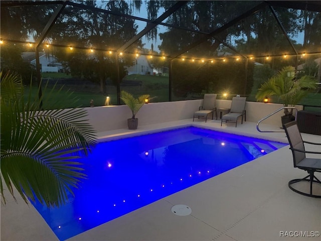 2745 N Canterbury Lake Dr, Hernando, FL 34442 - pool at night featuring a patio, an outdoor pool, and a lanai