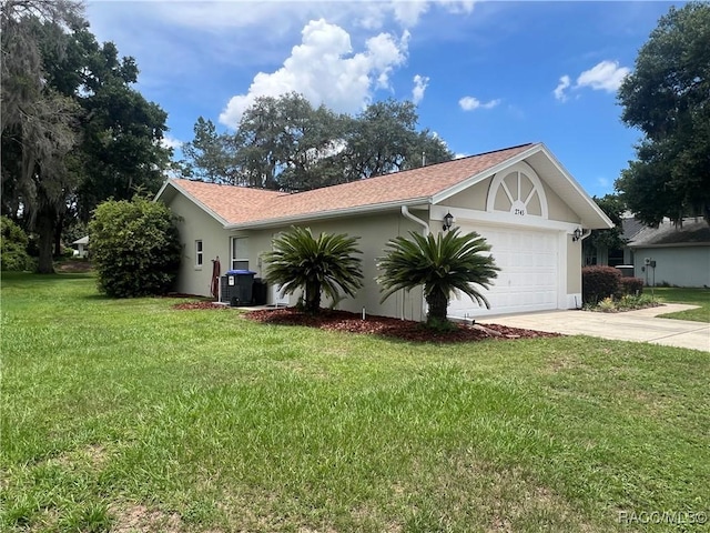 2745 N Canterbury Lake Dr, Hernando, FL 34442 - view of home's exterior with an attached garage, concrete driveway, stucco siding, and a yard