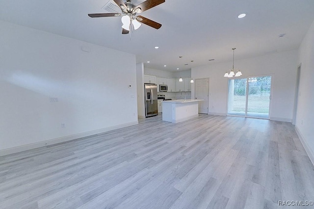 unfurnished living room with light hardwood / wood-style flooring, ceiling fan with notable chandelier, and sink