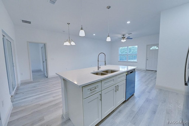 kitchen featuring dishwasher, sink, pendant lighting, a center island with sink, and ceiling fan with notable chandelier