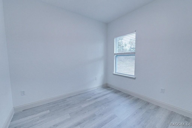 spare room with light wood-type flooring