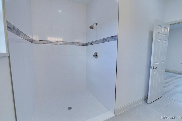 bathroom featuring a tile shower and hardwood / wood-style floors