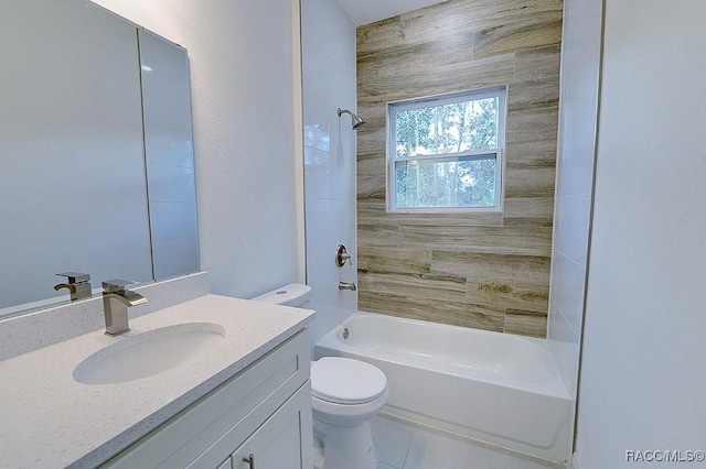 full bathroom with vanity, tile patterned floors, tiled shower / bath combo, and toilet