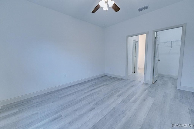 spare room featuring ceiling fan and light hardwood / wood-style floors