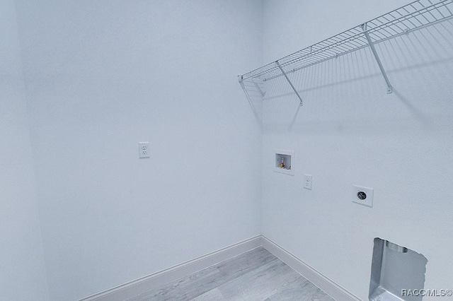 laundry area with hookup for an electric dryer, washer hookup, and light wood-type flooring