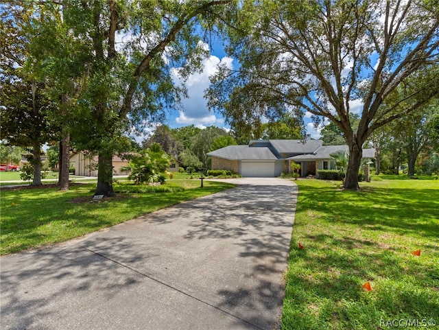 view of front of home featuring a garage and a front yard