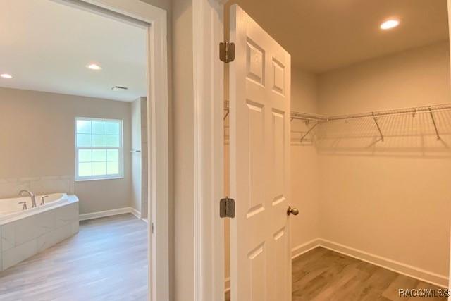 653 E Connecticut Ln, Hernando, FL 34442 - walk in closet with wood finished floors