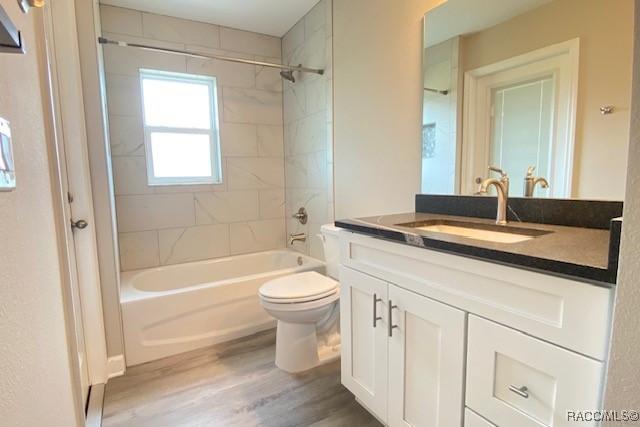 653 E Connecticut Ln, Hernando, FL 34442 - bathroom with vanity, wood finished floors, and shower / bath combination