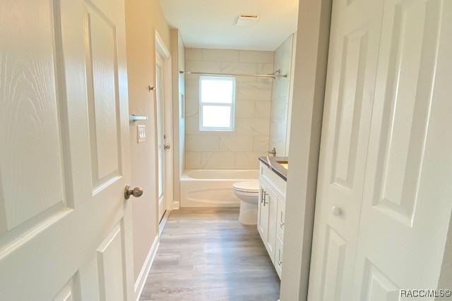 653 E Connecticut Ln, Hernando, FL 34442 - bathroom featuring vanity, shower / washtub combination, and wood finished floors
