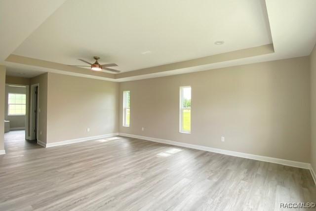 653 E Connecticut Ln, Hernando, FL 34442 - unfurnished room with a raised ceiling, wood finished floors, and ceiling fan
