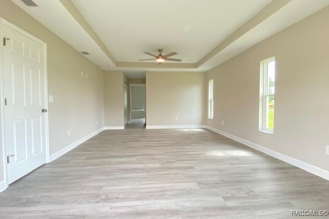 653 E Connecticut Ln, Hernando, FL 34442 - unfurnished room featuring a raised ceiling, ceiling fan, and light wood finished floors