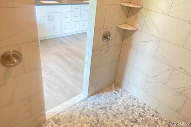 653 E Connecticut Ln, Hernando, FL 34442 - bathroom featuring a tile shower and double vanity