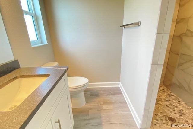 653 E Connecticut Ln, Hernando, FL 34442 - full bathroom with vanity, a tile shower, and wood finished floors