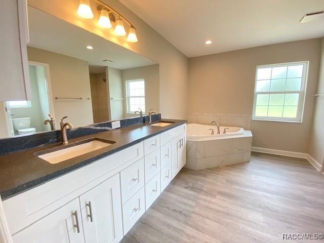 653 E Connecticut Ln, Hernando, FL 34442 - full bath featuring wood finished floors, double vanity, a bath, and recessed lighting