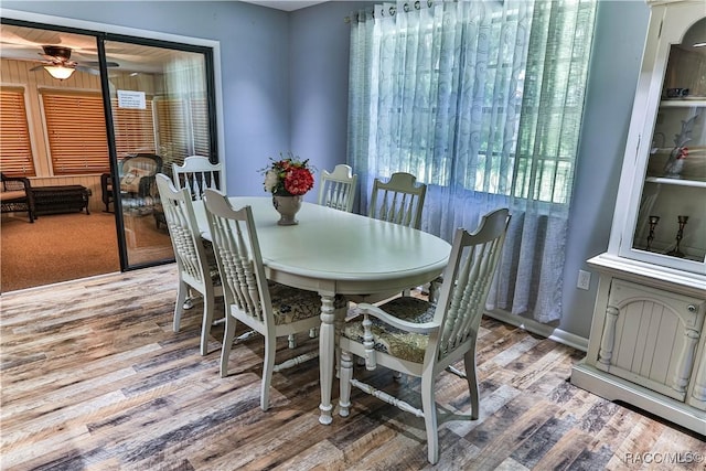 dining space with hardwood / wood-style flooring and ceiling fan