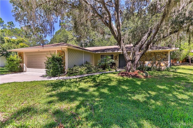 ranch-style house featuring a garage and a front yard