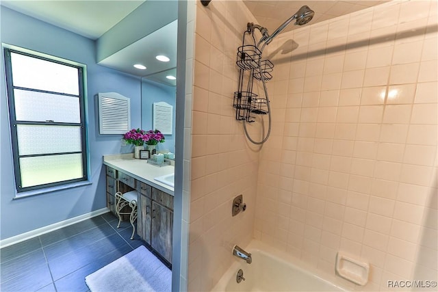 bathroom featuring vanity, tiled shower / bath combo, and a healthy amount of sunlight