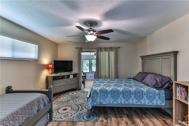 bedroom featuring ceiling fan, a textured ceiling, and hardwood / wood-style flooring