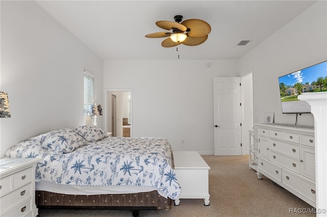 bedroom featuring ceiling fan, visible vents, and light colored carpet