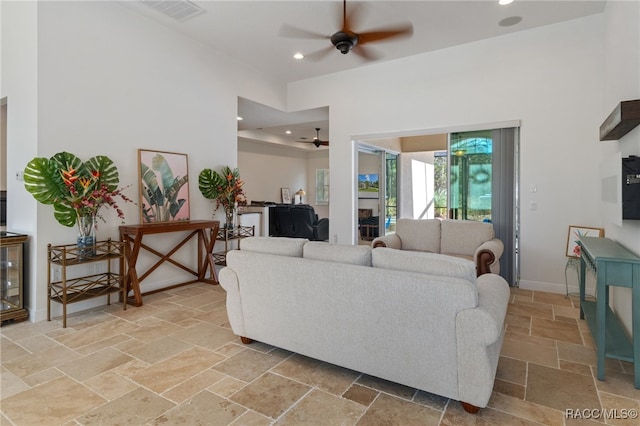 living room with ceiling fan, recessed lighting, visible vents, baseboards, and stone tile flooring