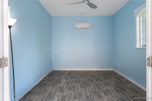 unfurnished room featuring ceiling fan, dark wood-style flooring, a wall mounted AC, and baseboards