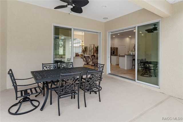 view of patio / terrace with ceiling fan and outdoor dining space