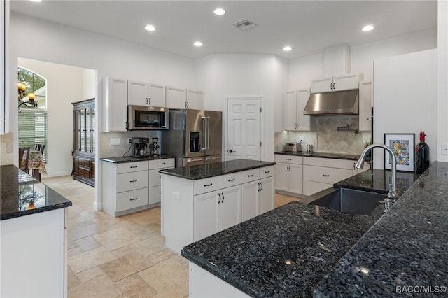 kitchen with a kitchen island, stainless steel appliances, under cabinet range hood, white cabinetry, and a sink