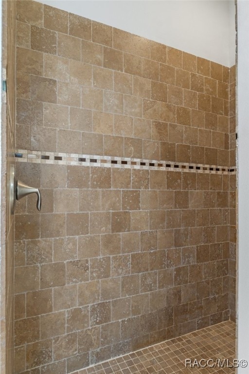 bathroom with tiled shower