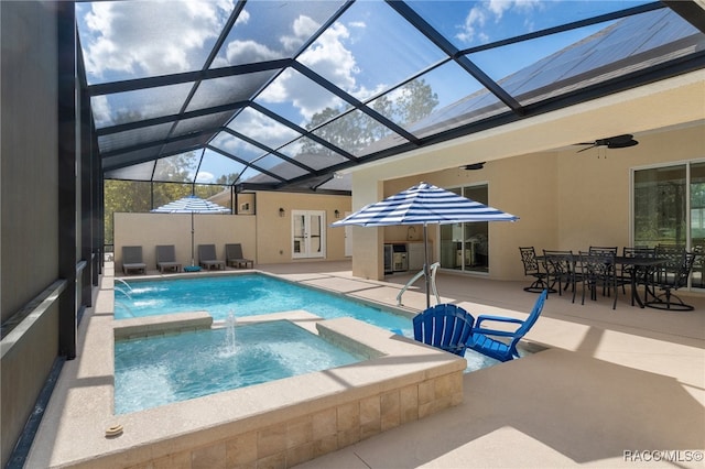 pool with an in ground hot tub, french doors, a patio area, and a lanai