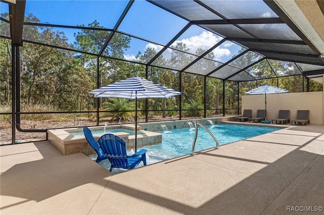 view of swimming pool featuring a lanai, a patio area, and a pool with connected hot tub