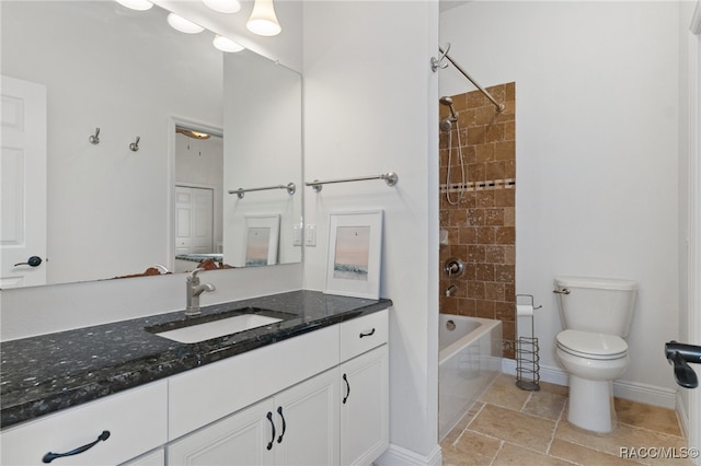 full bathroom with stone tile floors, shower / bathtub combination, toilet, vanity, and baseboards