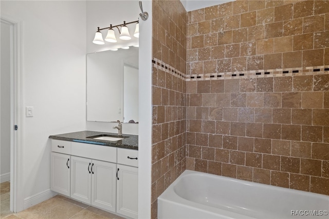 bathroom with tile patterned floors, washtub / shower combination, baseboards, and vanity