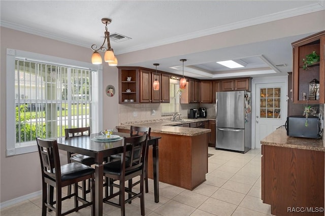4015 E Parsons Point Rd, Hernando, FL 34442 - kitchen featuring freestanding refrigerator, open shelves, a peninsula, backsplash, and hanging light fixtures