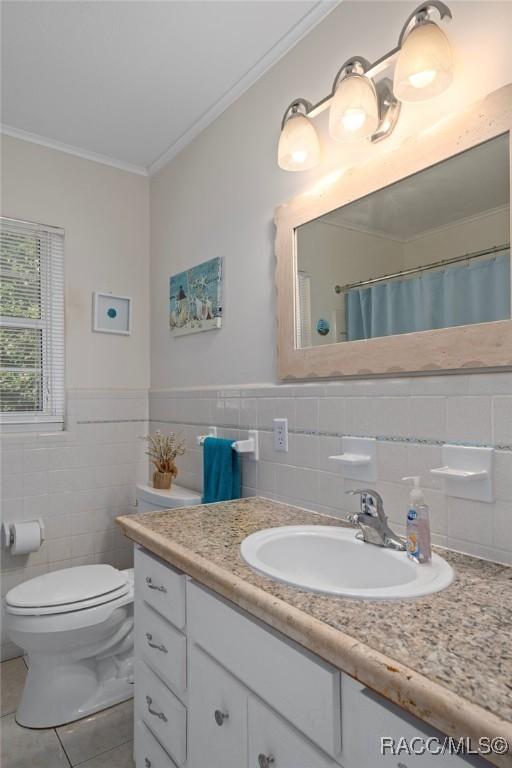 4015 E Parsons Point Rd, Hernando, FL 34442 - full bathroom featuring ornamental molding, tile walls, vanity, tile patterned floors, and curtained shower