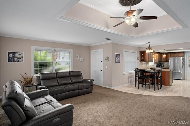 4015 E Parsons Point Rd, Hernando, FL 34442 - living area with a tray ceiling, ceiling fan, ornamental molding, and light carpet