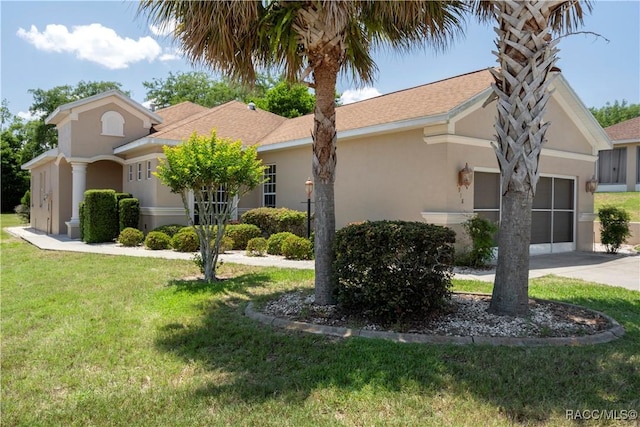 1918 W Crystal Mae Path, Lecanto, FL 34461 - view of side of property with an attached garage, a lawn, stucco siding, and driveway