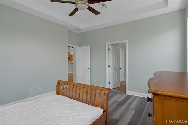 1918 W Crystal Mae Path, Lecanto, FL 34461 - bedroom featuring ceiling fan, a raised ceiling, baseboards, wood finished floors, and visible vents