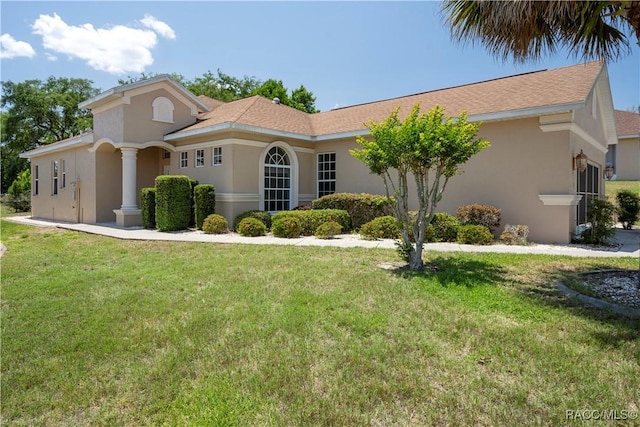 1918 W Crystal Mae Path, Lecanto, FL 34461 - mediterranean / spanish-style house with stucco siding and a front yard